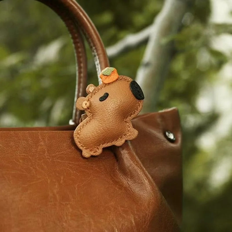 Lucky Capybara Leather Bag Charm – Handmade Sheepskin Capybara with Persimmon Hat | Adjustable Clip-On Pendant | Whimsical Good Luck Gift