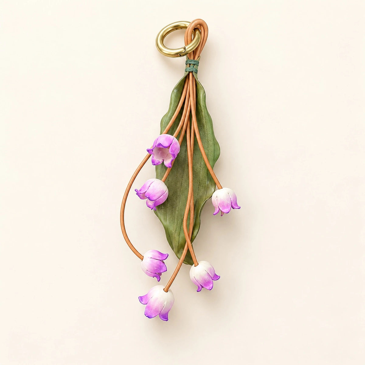 Lavender Valley Bells sculpted cowhide leather bag charm with six purple and ivory flowers, olive-green leaf, and gold-tone ring