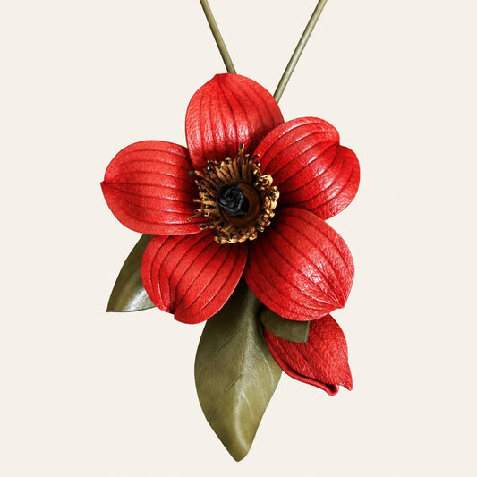 Red kapok flower leather bag charm with five sculpted petals, a dark center, a red bud and olive green leaves on an ivory background.