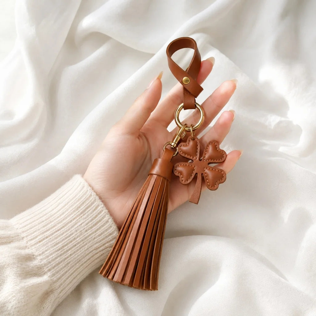 Amuleto de bolsa con borla de cuero Trébol de la suerte – Llavero de cuero plena flor hecho a mano | Elegante colgante de bolso marrón | Regalo simbólico para ella