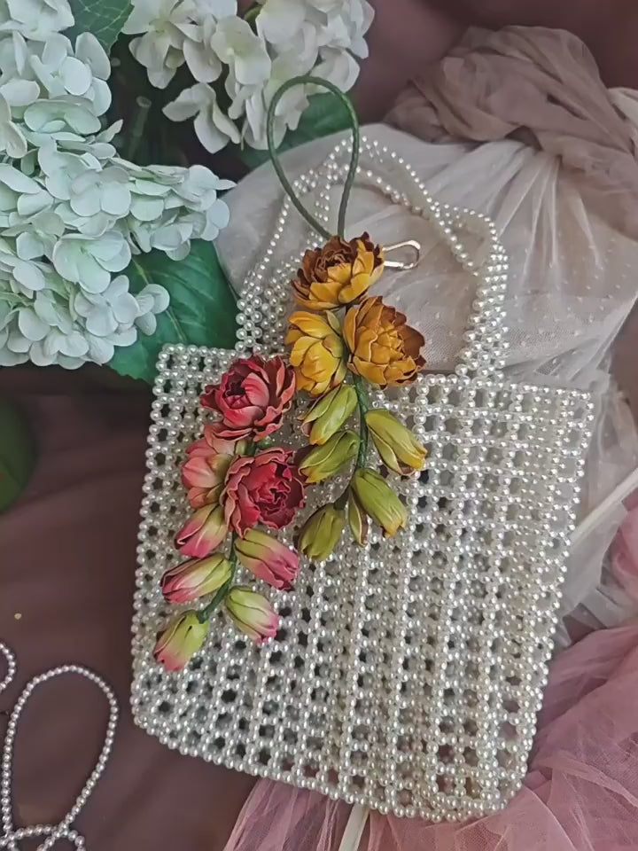 Moonlit Tuberose leather bag charms in yellow and pink, showing sculpted flowers, cascading buds, and hand-held details.